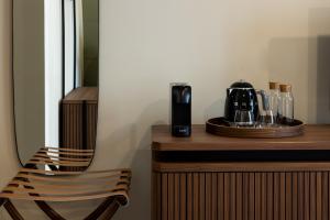 a chair sitting on a counter with a coffee maker at Cà Bèla - Pergolesi in Milan