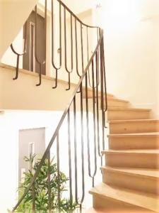 a set of stairs with a wrought iron railing at Sweet Apartments Downtown in Vila Nova de Famalicão