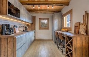 a kitchen with wooden cabinets and a counter top at Awesome Home In Barlete With Kitchen 