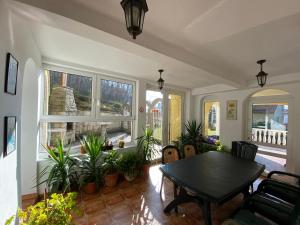 a living room with a table and some plants at Pensjonat Miranda in Polanica-Zdrój