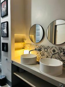 due lavandini in un bagno con due specchi di Sweet Life House Rome Cavour a Roma