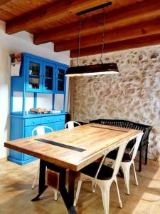 a dining room with a wooden table and blue cabinets at Acogedora casa del siglo XIX 