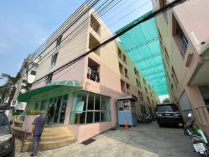 a man standing in front of a building at My Space 77 in Ban Khlong Khwang Klang