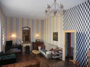 a living room with a couch and a chandelier at MAISON ST CHRISTOPHE in Lézardrieux