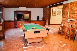 a pool table in the middle of a room at MTH in Nelspruit