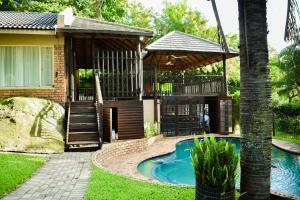 a house with a swimming pool in the yard at MTH in Nelspruit