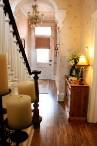 a hallway with a stairway with a lamp and a door at Grange View Bed and Breakfast in Ayr