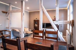 a dining room with a wooden table and chairs at Apartment am Markt in Aschersleben