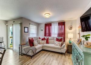 a living room with a white couch and red curtains at The Elizabeth in Jacksonville