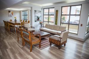a living room with a couch and a table at Lisboa Hotel in Poços de Caldas