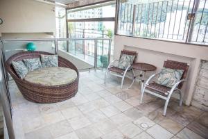 a balcony with two chairs and a table at Lisboa Hotel in Poços de Caldas