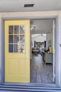 a yellow door leading into a living room at PV Clubhouse in Ponte Vedra Beach
