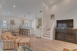 a living room with a flat screen tv and a kitchen at Turtles Nest in Ponte Vedra Beach