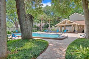 a swimming pool in a yard with trees at Turtles Nest in Ponte Vedra Beach
