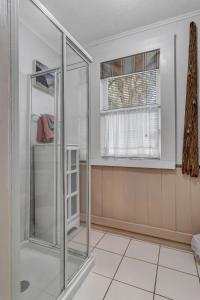 a glass shower in a room with a window at St Augustine Carriage House in Saint Augustine +23 photos