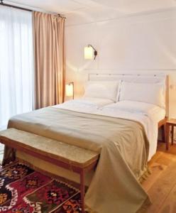 a bedroom with a large bed and a window at Louis Hotel in Munich