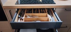 a drawer in a cabinet filled with knives at Apartament 4 You in Rösslingen