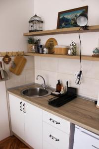 a kitchen counter with a sink and a keyboard at Bohome studio sa terasom - FREE PARKING in Vranje