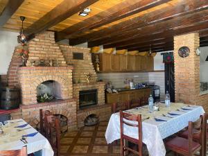 a kitchen with a table and a brick oven at Pensiunea Contesa in Sovata