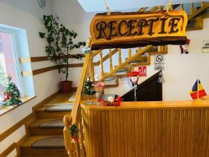 a staircase with a sign that reads associate at Pensiunea Contesa in Sovata