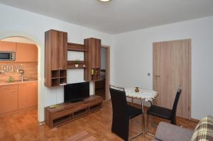 a living room with a table and a kitchen at Land-Hotel Am Wald Garni in Greiz