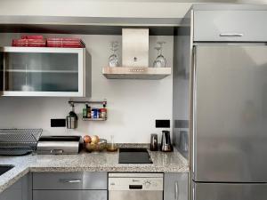 a kitchen with a stainless steel refrigerator at Casa Vacacional Alcazabilla in Antequera