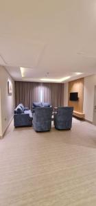 a large room with two couches and a television at شقق ظلال النخيل in Al Khobar