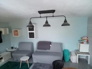 a living room with two chairs and two lights at Apartament w Chmurach in Jaworzynka