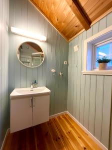 a bathroom with a sink and a mirror at The blacksmith's place - Cozy Rorbu in Lofoten in Sørvågen