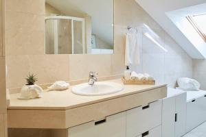 a bathroom with a sink and a mirror at Apartamento con terraza a un paso de la playa in Gijón