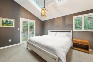 a bedroom with a large bed and windows at Shadowood Serenity in Waynesville