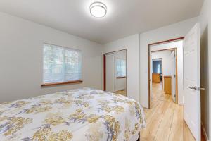 a bedroom with a bed and a window and a door at The Little Wing Roost in Renton