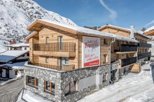 a building in the snow with a sign on it at The Moss - Your unique hideaway in Obergurgl