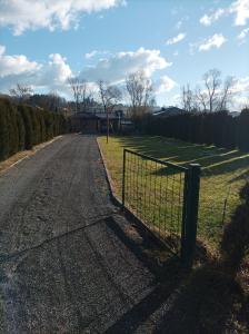 a fence on the side of a road at Vikendica Raj u prirodi in Prijedor