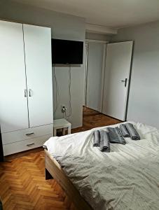 a bedroom with a bed with two pillows on it at Fenix Apartman in Zaječar