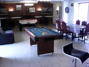 a room with a pool table and ping pong ball at le logis gourmand a Payroux in Payroux