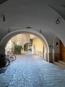 an archway in a building with bikes parked in it at Apartment Obstplatz - Free Parking included in Bolzano