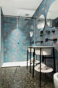 a bathroom with a shower and a sink and a mirror at Luxury Loft near Duomo and Garage in Milan