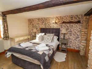 a bedroom with a bed with towels on it at Garden Cottage in Doncaster