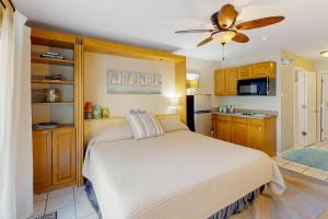 1 dormitorio con 1 cama y ventilador de techo en Breakwater Bungalow, en Navarre