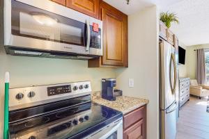 a kitchen with a stove and a microwave at Pirates Bay B109 in Fort Walton Beach