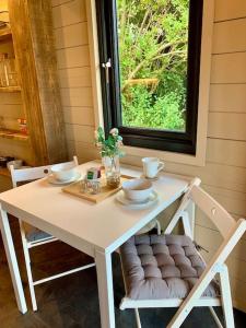 a white table with two chairs and a window at Luxury Garden Lodge With Free Parking in Chestfield