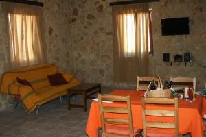 a living room with a table and a couch at Kapsali House in Keratokampos