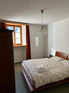 Postel nebo postele na pokoji v ubytování Casa Flavia affittasi nel centro di Poschiavo