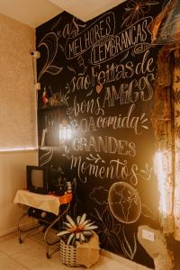 a wall with writing on it in a room at Pousada Sol & Mar in Guaratuba