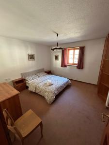 Llit o llits en una habitació de Casa Flavia affittasi nel centro di Poschiavo