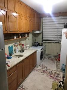 a kitchen with wooden cabinets and a washer and dryer at Private Room in Istanbul #71 in Istanbul