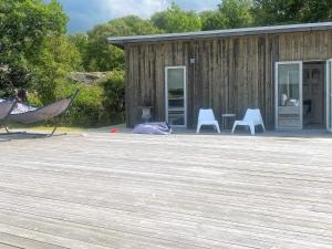 a hammock on a deck in front of a building at Holiday home ELLÖS IX in Ellös