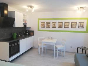 a kitchen with a table and a white table and chairs at Apartment Ochsenfurt Schmidl in Ochsenfurt