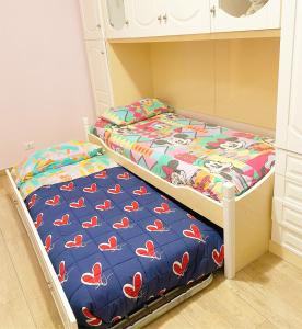 a small bedroom with a bed with red shoes on it at La Casa Di Rosa in Oliveri